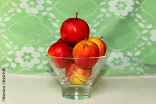 Fototapeta Naklejka Na Ścianę i Meble -  Small red-yellow apples in a vase.white background