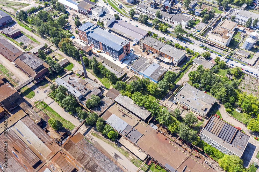 drone image of suburb industrial area with old warehouses and storages. rusty roofs, top view