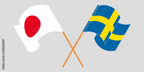 Crossed and waving flags of Sweden and Japan