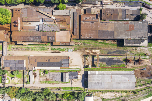 old rusty roofs of warehouses at urban industrial zone. aerial top view © Mr Twister