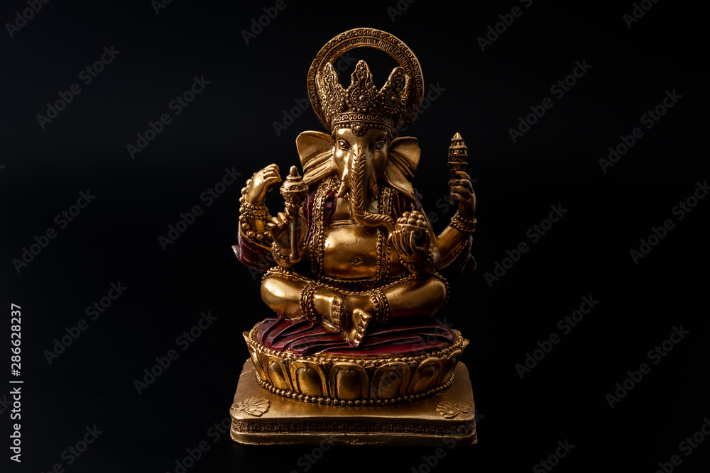 Happy Diwali, divine bless and spiritual harmony conceptual idea with Ganesh the hindu half elephant god of beginnings in meditation pose isolated on black background with clipping path cutout Happy Diwali, divine bless and spiritual harmony conceptual idea with Ganesh the hindu half elephant god of beginnings in meditation pose isolated on black background with clipping path cutout