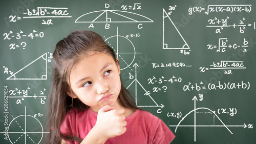 little girl thinking about mathematics problem photo