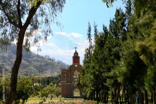 replica of the viceregal church, in front of the snowy huascaran, in the holy field of yungay, huaraz, ancash, peru. Peruvian cemetery from the 1970 earthquake. photo