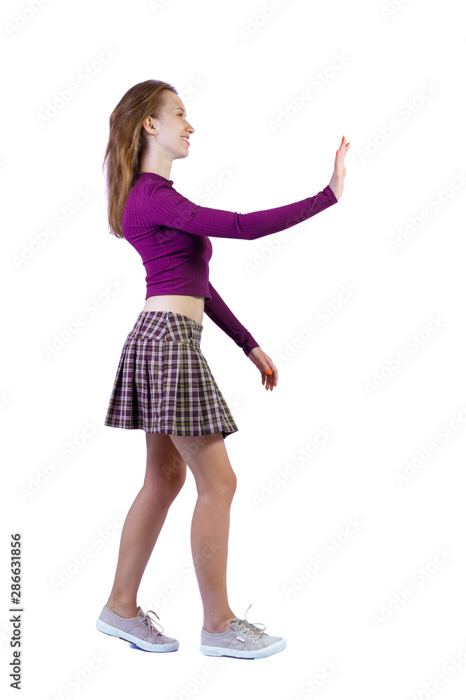 Back view of a woman who comes welcomes someone with hand. Back view of a woman who comes welcomes someone with hand.