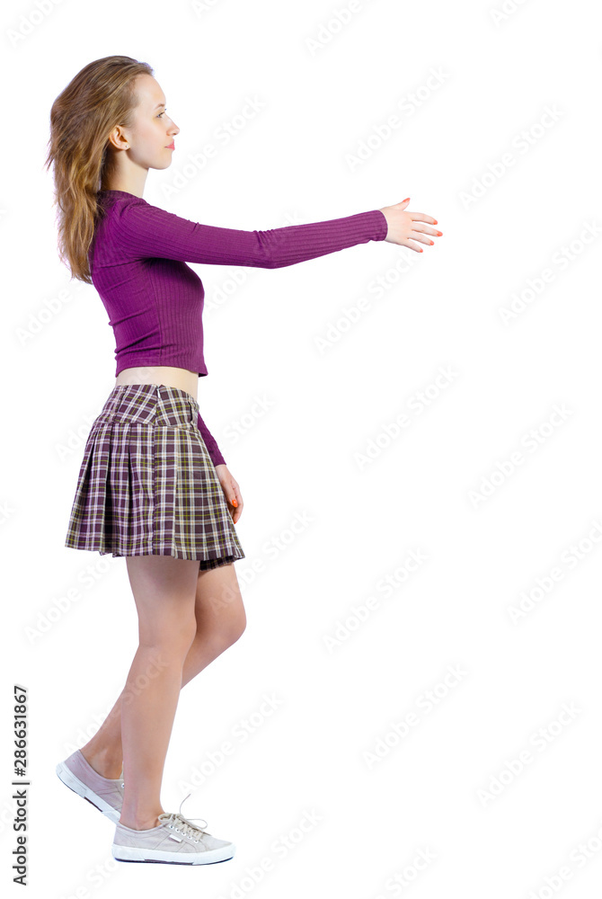 Back view of a woman who comes welcomes someone with hand. Back view of a woman who comes welcomes someone with hand.