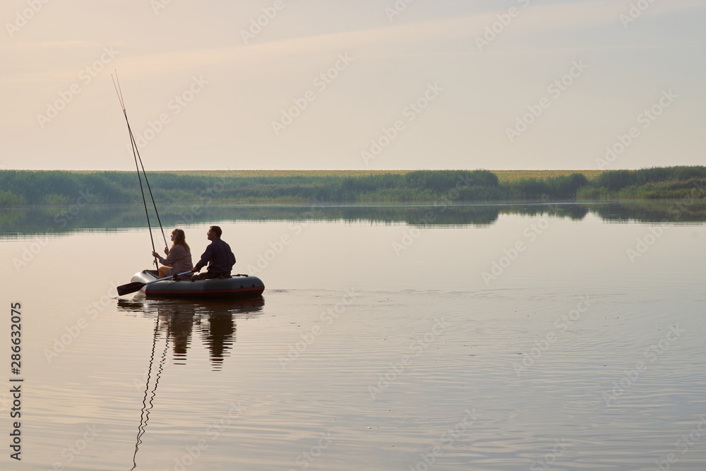 An elderly people fishing in boat around forest