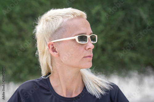 Portrait of a blonde girl on a background of nature.