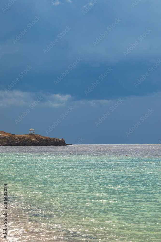 Storm clouds over the azure waters of the sea