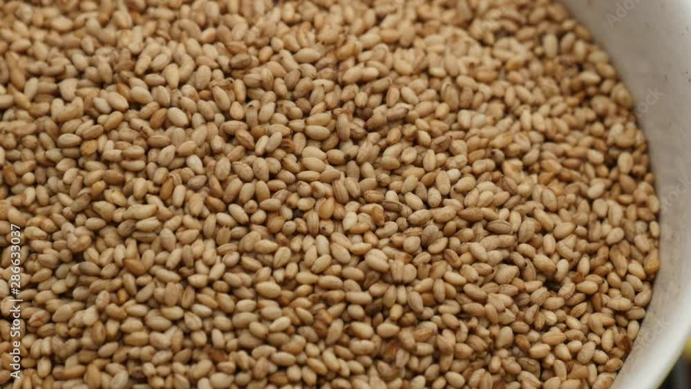Close up of rotate toasted sesame seeds Close up of rotate toasted sesame seeds