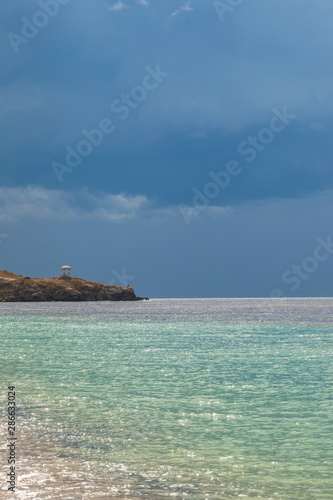 Storm clouds over the azure waters of the sea