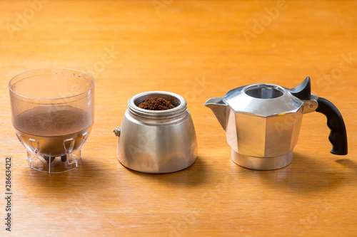 Moka pot and coffee beans and grinder.