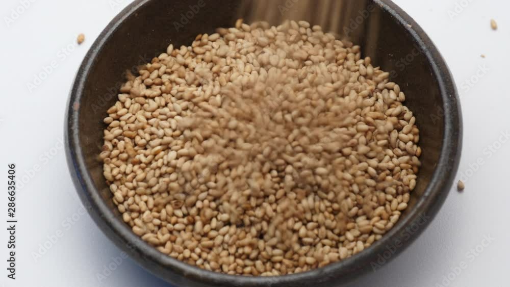 Pouring toasted sesame seeds Pouring toasted sesame seeds