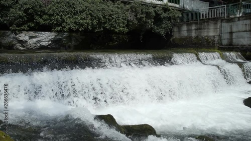 Bbridge over fast mountain river. Mountain river in Abkhazia. View of a fast moving river with rapids. photo