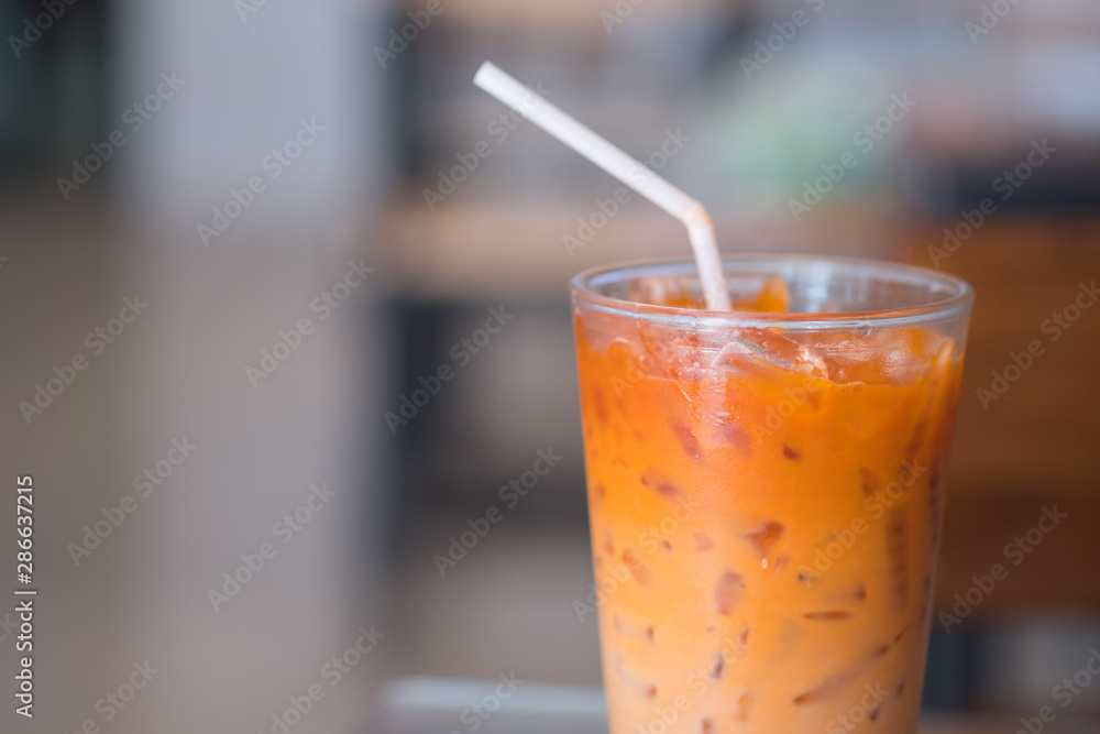 Thai milk tea in glass with straw Thai milk tea in glass with straw
