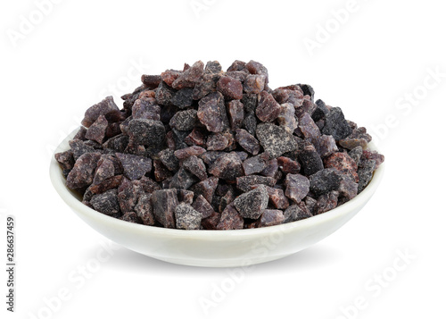 Himalayan black volcanic rock salt in shell blow isolated on white background. This has clipping path. 
