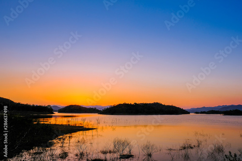 Fototapeta Naklejka Na Ścianę i Meble -  Sunset at lake, Kaeng Krachan Dam on Silhouette