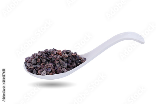 Himalayan black volcanic rock salt in spoon isolated on white background. This has clipping path.    