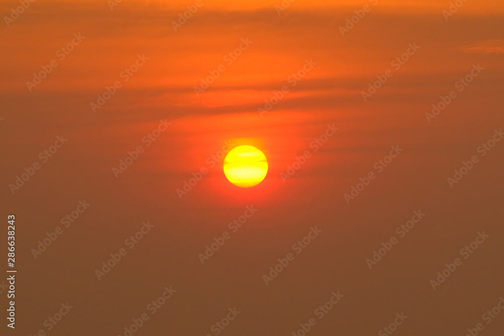 Gorgeous scenic of the strong sunrise with silver lining and cloud on the orange sky