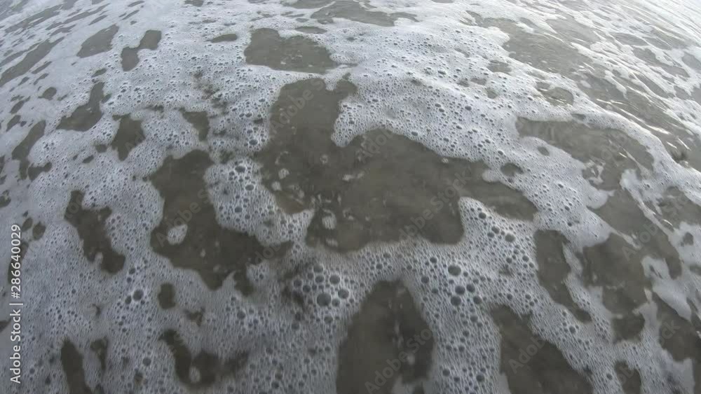 Heart drawn in the sand washed away by wave rolling on beach covering it back up with sand. Heart drawn in the sand washed away by wave rolling on beach covering it back up with sand.