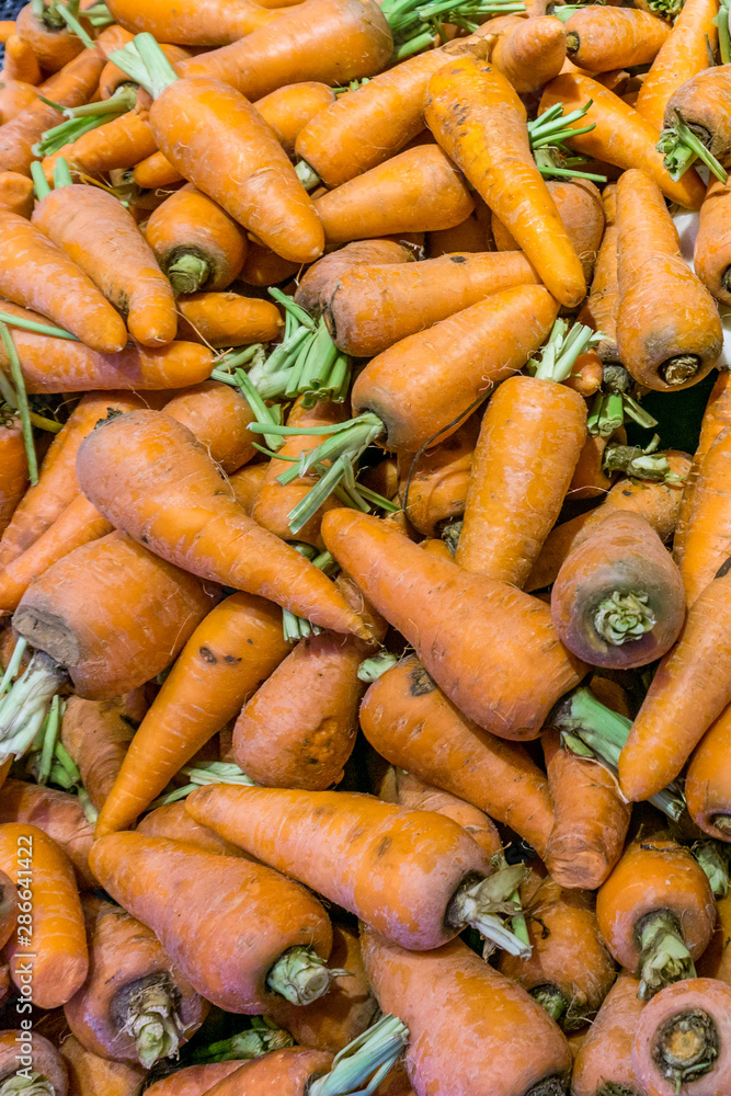 Vertical photo of fresh carrots for sale at market Vertical photo of fresh carrots for sale at market