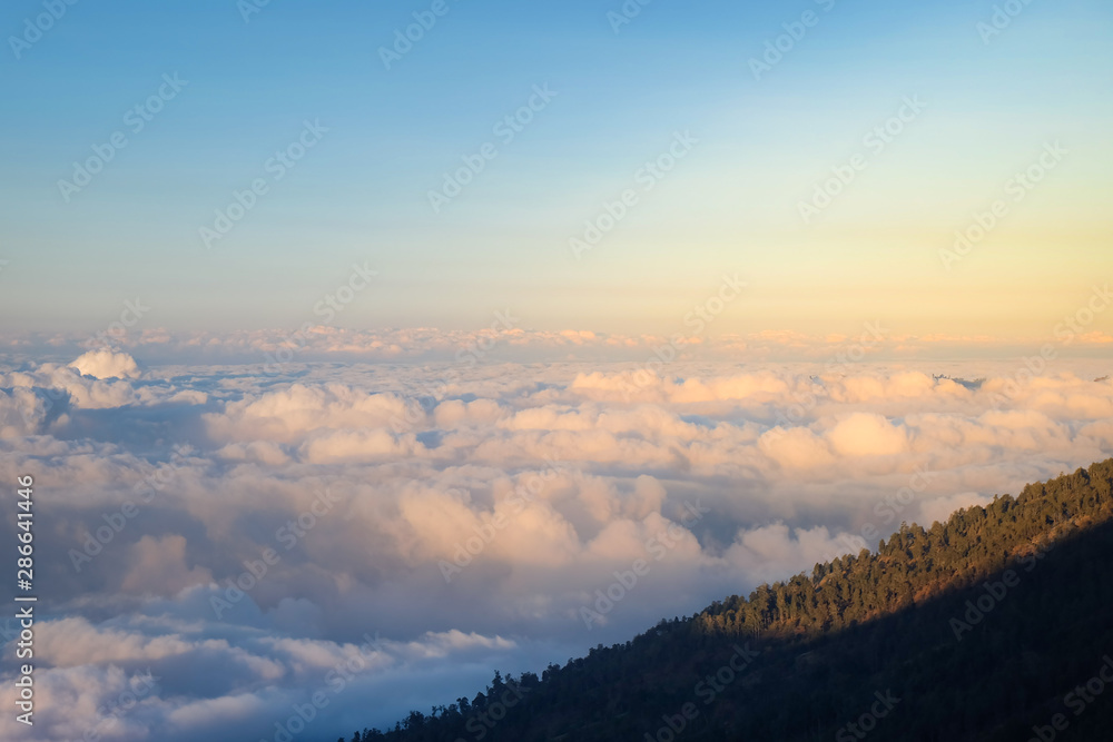 Sunset on the hill, above the clouds in the valley  of Mount Rinjani, view and scene from trekking, among the clouds. 