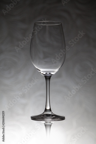 Glass wine glass stands on a blurred background