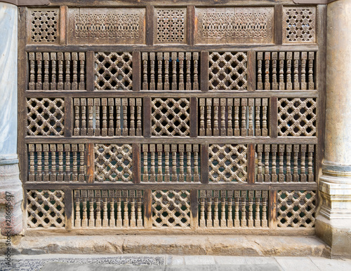 Front view of interleaved wooden arabisk wall - Mashrabiya, Facade of public historic mosque of Amir Al-Maridani, Cairo, Egypt photo