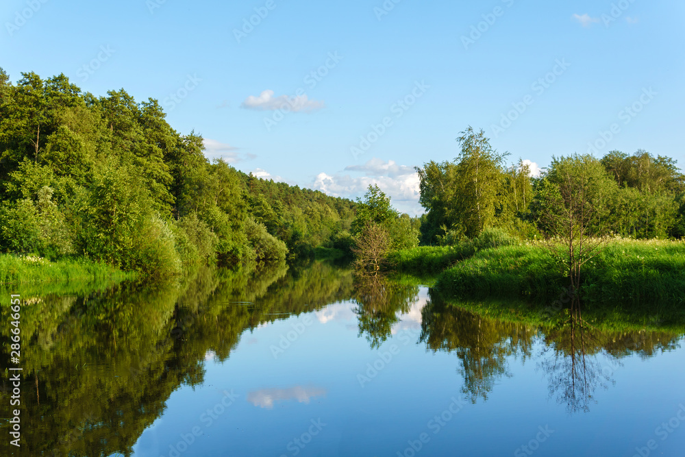 summer landscape of a calm oxbow lake with wooded shores summer landscape of a calm oxbow lake with wooded shores