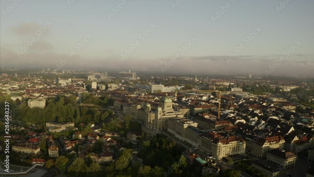 The Bundeshaus in Bern, Switzerland, in an aerial shot. Clouds are partly covering the architecture of the capital in Switzerland. The Bundeshaus in Bern, Switzerland, in an aerial shot. Clouds are partly covering the architecture of the capital in Switzerland.