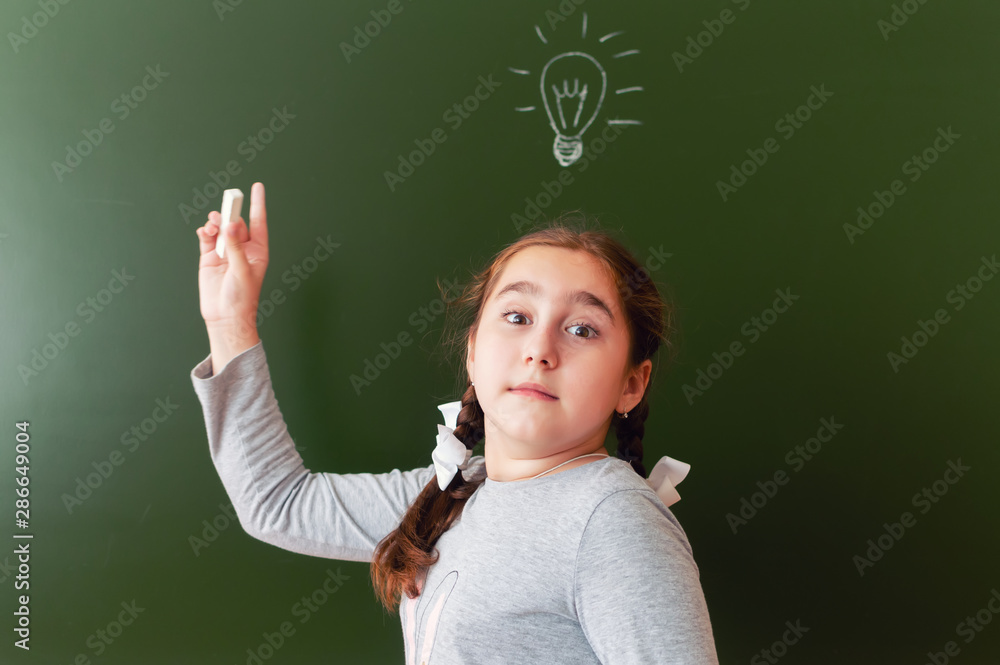 A schoolgirl at the blackboard was able to find a solution to the problem. inspiration. the idea came