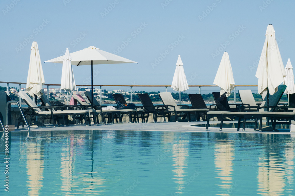 Fototapeta premium Weekend vibes and summertime sunbathing near the swimming pool 