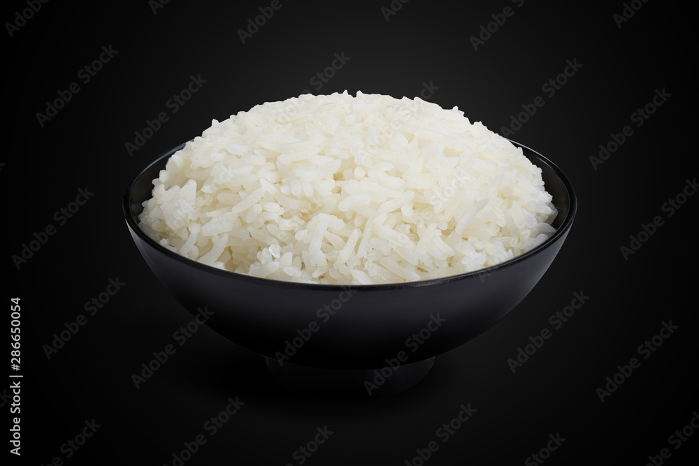 Jasmine cooked rice in a black bowl isolated on the black background. This has clipping path. Jasmine cooked rice in a black bowl isolated on the black background. This has clipping path.