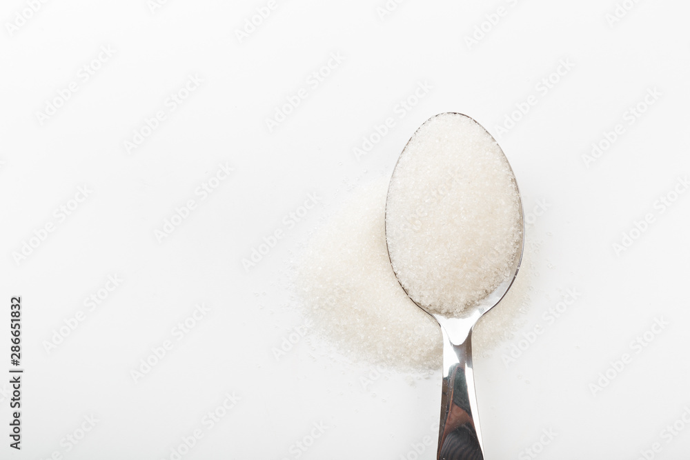 Spoon of fine granulated sugar isolated on white - Image Spoon of fine granulated sugar isolated on white - Image