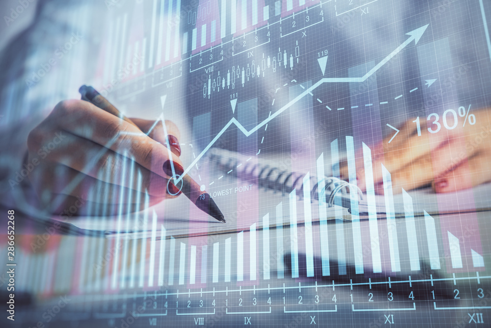 Double exposure of woman's hands making notes with forex graph hologram. Concept stock market analysis. Double exposure of woman's hands making notes with forex graph hologram. Concept stock market analysis.