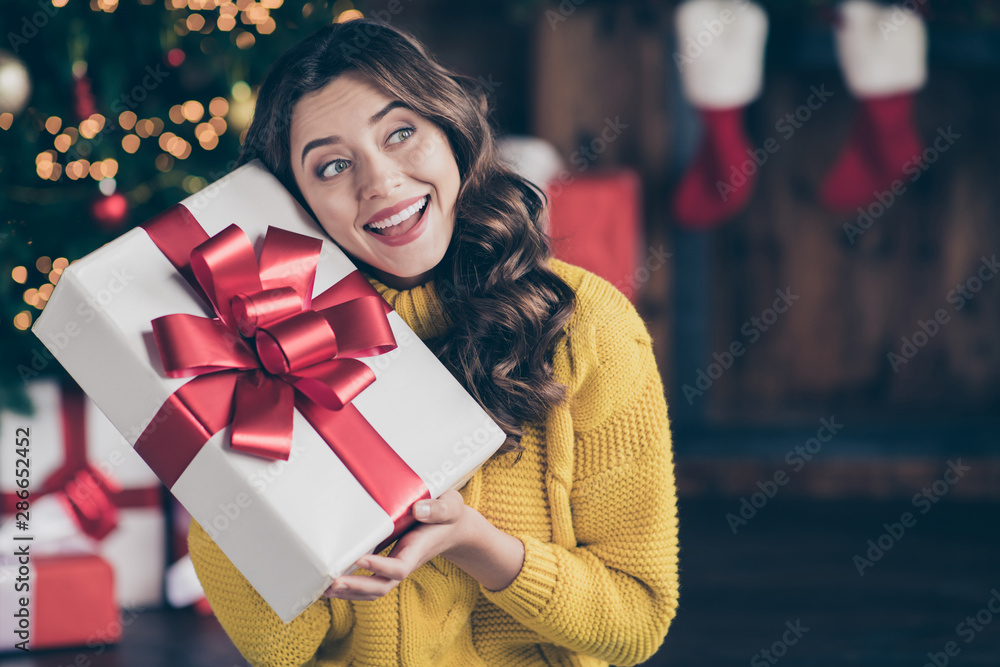 Close up photo of cute nice charming beautiful attractive girlfriend listening to what is inside box wearing jeans denim yellow pullover Close up photo of cute nice charming beautiful attractive girlfriend listening to what is inside box wearing jeans denim yellow pullover