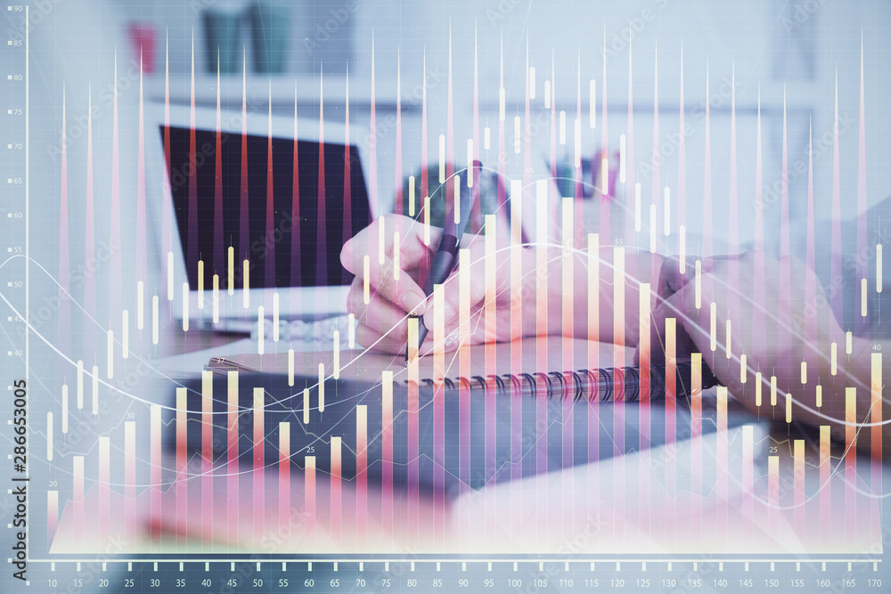 Financial graph displayed on woman's hand taking notes background. Concept of research. Double exposure Financial graph displayed on woman's hand taking notes background. Concept of research. Double exposure