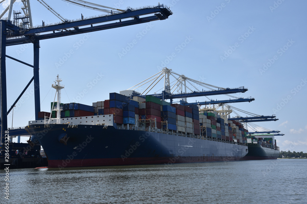 Fototapeta premium Cargo container ship during cargo operations in the port of Charleston, South Carolina.