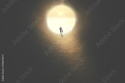 Fotobehang man with suitcase running to the exit of a tunnel illuminated of the sun
