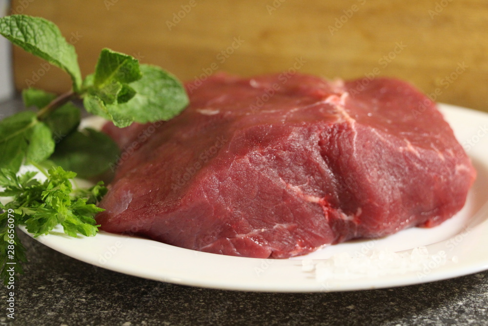 raw beef steak on a plate