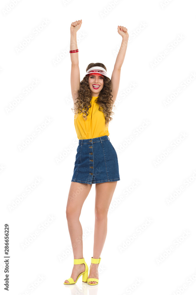 Happy Young Woman Is Holding Arms Raised And Cheering Happy Young Woman Is Holding Arms Raised And Cheering