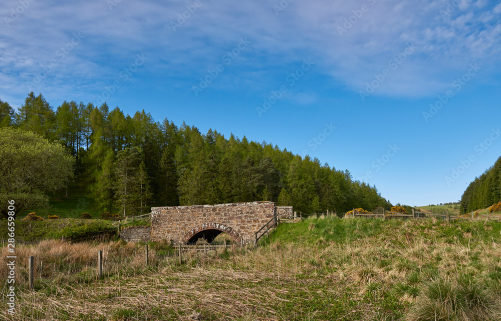 A small arched single span stone Road Bridge in the Quharity Valley in the deepest Angus Glens, near to Glen Prosen. Scotland. A small arched single span stone Road Bridge in the Quharity Valley in the deepest Angus Glens, near to Glen Prosen. Scotland.