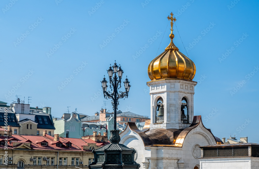 Golden small dome of Cathedral of Christ the Saviour, the second tallest Orthodox church in the world, landmark of Moscow, Russia, under blue sky in summer season