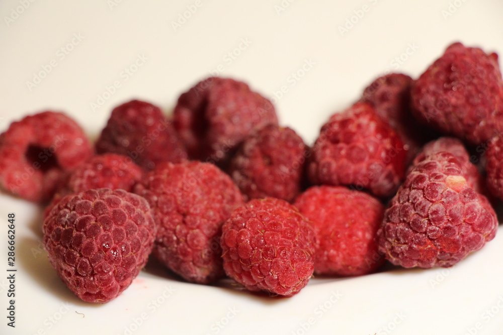 red raspberries on a white background red raspberries on a white background