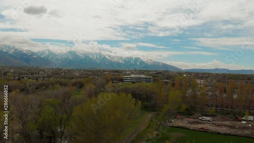 Salt Lake City Wasatch Mountains boom rising view reveal shot of buildings & freeways. Aerial drone footage. Overcast autumn day, snow in mountains. photo