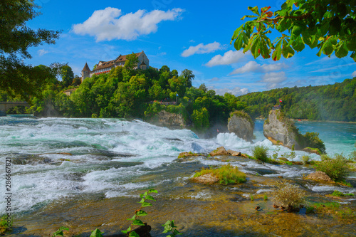 At the Rhine Falls in Switzerland. - There are much bigger waterfalls  but this  small  waterfall has something fascinating for many visitors because of the castle above and the forest around it.