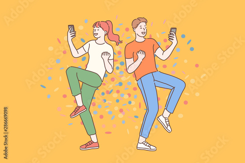 Emotional wow concept. Surprised young guy and girl blogger reading shocked news in message on mobile phone. Friends enjoy the good news in their smartphone.