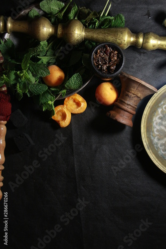 bowl with tobacco for hookah. fruits on a black background. smoking shisha