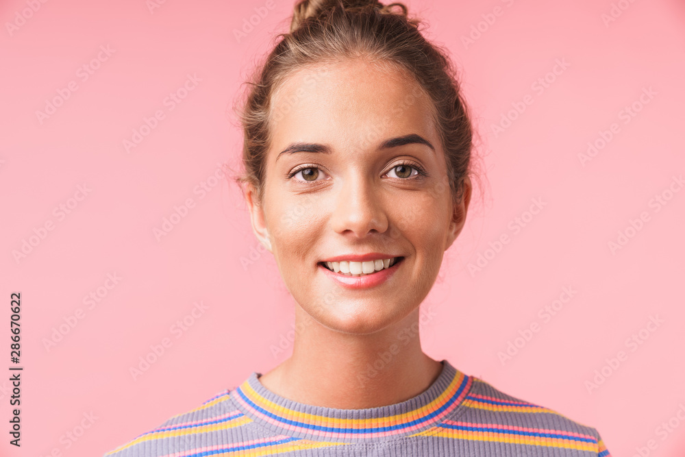 Image closeup of positive beautiful woman dressed in colorful clothes smiling at camera with happy look Image closeup of positive beautiful woman dressed in colorful clothes smiling at camera with happy look