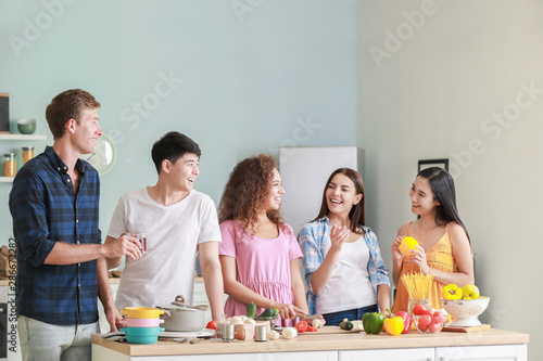 Happy friends cooking toget...