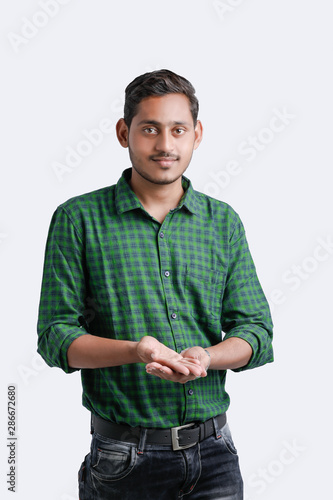 young indian college student showing direction
